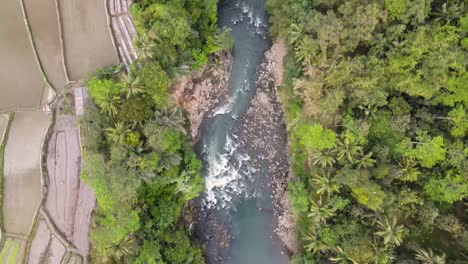 Overhead-drone-shot-of-river-with-rapids-and-steep-rocks