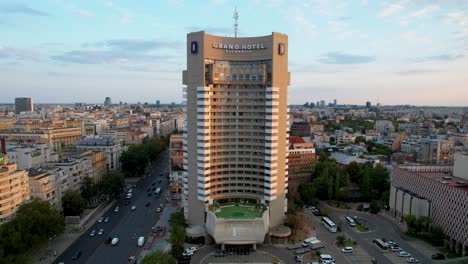 Aerial-View-Of-Intercontinental-Envailed-In-Orange-Colors-At-Sunrise,-Bucharest