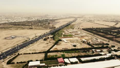 Highway-in-Kuwait-desert-landscape,-cars-driving