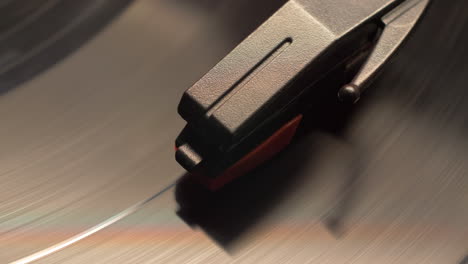 vintage-style-retro-record-player-needle-dropping-on-to-a-spinning-vinyl-music-album,-macro