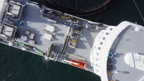 Bird's-eye-view-drone-shot-of-the-deck-on-a-docked-fish-farming-vessel