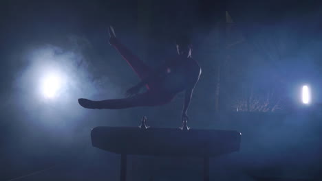 Male-Gymnast-performs-exercises-from-the-Olympic-program-on-Pommel-horse-performing-spins-and-rolls-in-slow-motion