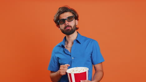 Man-in-3D-glasses-eating-popcorn-and-watching-interesting-tv-serial,-sport-game-film,-online-movie