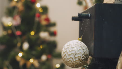 Hanging-Christmas-decoration-on-tree-with-Christmas-lights.-Decorating-on-Christmas-tree-with-ball.