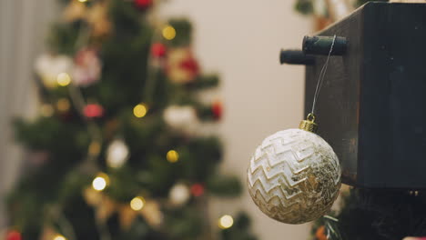 Hand-woman-decorating-on-Christmas-tree-with-Christmas-glow-lights.