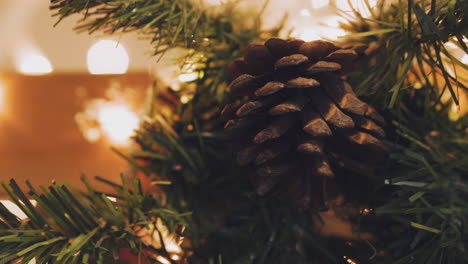 Hand-of-woman-decorating-Christmas-tree-with-Christmas-glow-lights.
