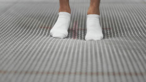 Close-up-of-the-legs-of-the-gymnast-go-to-the-trampoline-grid