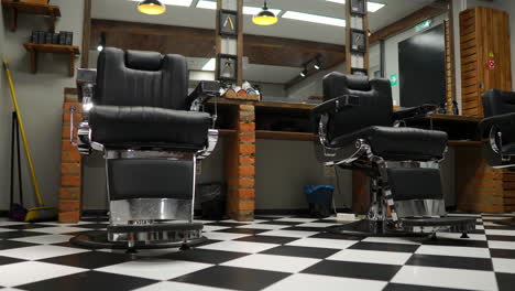 Vintage-hanging-lamps-in-hairdressing-salon.-Ceiling-retro-lamp-in-barber-shop.-Barber-pole.-Hair-salon-interior.-Metal-ceiling-lights-in-barbershop