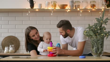 Parents-with-baby-boy-playing-with-wooden-game
