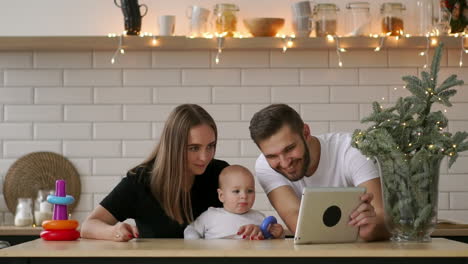 Parents-with-baby-boy-playing-with-digital-tablet