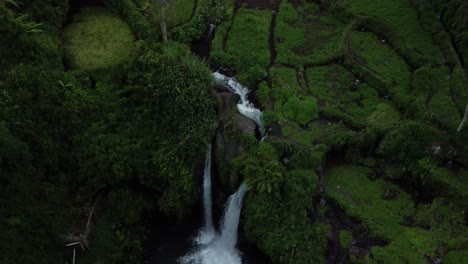 The-Twin-Arum-Waterfall-with-an-Aerial-Drone-Shot-Lowering-Down-to-the-Pool-Below-with-Scenic-Vegetation-Landscape