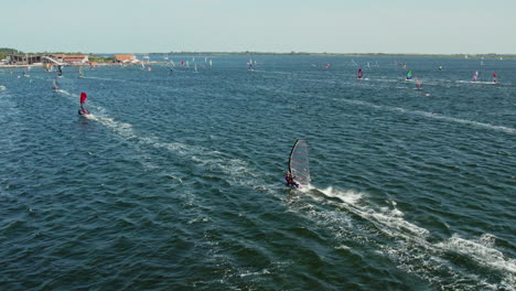 Aerial-View-Of-People-Windsurfing-In-The-Sea-In-Ouddorp,-Netherlands---drone-shot