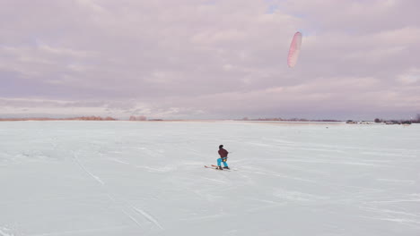 man-ski-on-snow-kite-holds-an-action-camera-and-takes-a-picture-of-Selfie.