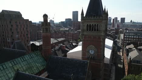Aerial-drone-flight-around-Manchester-Crown-Court-Clocktower-giving-a-view-of-the-Manchester-skyline-with-the-skyscrapers-in-the-background