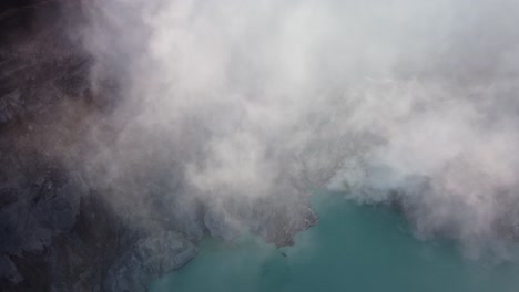Aerial-Drone-Shot-Looking-Down-Through-the-Sulfuric-Gases-of-Mount-Ijen-in-East-Java,-Indonesia