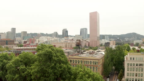 Aerial-shot-past-Old-Town-water-tank-towards-downtown-Portland-Oregon