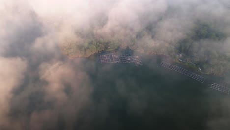 Aerial-view-over-low-clouds,-overlooking-traditional-fish-cages-of-Bali,-Indonesia