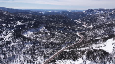 Aerial-View-of-Countryside-Road-in-Sunny-Winter-Landscape,-Mountain-Pass-in-Colorado-USA