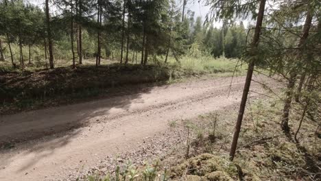 WRC-rally-race-fly-by-on-gravel-road-so-rocks-and-sand-everything-is-thrown-to-air