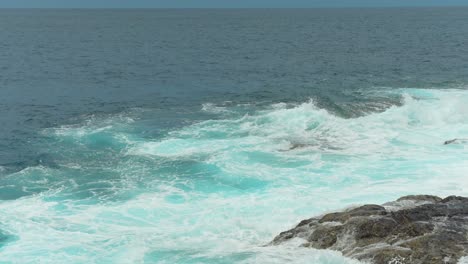 Powerful-waves-flowing-over-Tenerife-coastline,-handheld-view