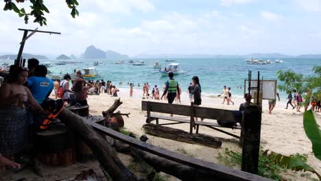 People-on-busy-Seven-Commandos-Beach-on-island-hopping-tour-in-popular-tourist-destination-of-El-Nido-in-Palawan,-Philippines