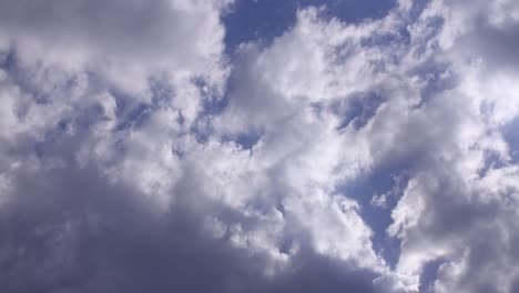 Clouds-passing-by-from-left-to-right-with-a-blue-sky-in-the-background