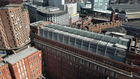 Aerial-drone-flight-over-the-Manchester-Astronomical-Society-Building-rooftop-heading-towards-London-Road-Fire-Station-Building