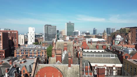 Aerial-drone-flight-over-the-Sackville-Building-in-Manchester-City-Centre-in-close-proximity-to-the-rooftops-with-a-view-of-Piccadilly-Gardens-in-the-background