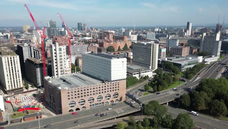 Aerial-drone-flight-alongside-The-Mancunian-Way-in-Manchester-giving-a-panoramic-view-of-Manchester-City-Centre
