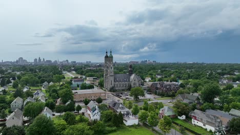 An-aerial-view-of-the-green-city-of-Buffalo,-New-York-with-storm-clouds-in-the-distance