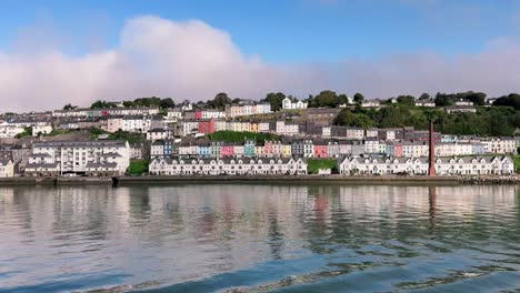 Sunny-day-over-Cobh-panorama,-a-view-from-the-water-with-row-of-houses,-blue-sky,-cathedral