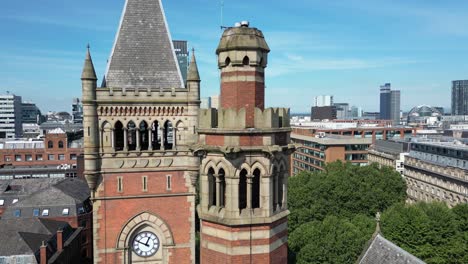 Aerial-drone-flight-around-Manchester-Crown-Court-clocktower-with-a-skyline-view-of-Manchester-skyscrapers