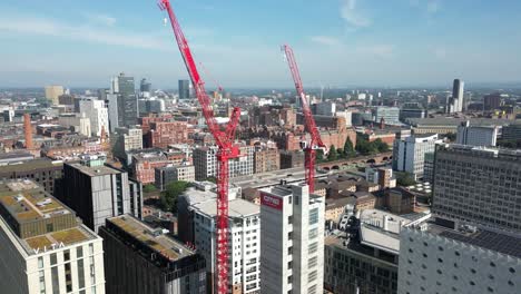 Aerial-drone-flight-of-a-building-under-construction-next-to-The-Mancunian-Way-on-Oxford-Road-giving-a-panoramic-view-of-the-city-of-Manchester