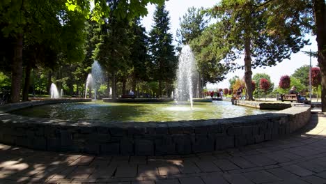 Fountains-on-city-park-in-a-hot-summer-day-cooling-the-ambient-in-park-frequented-by-elderly-and-kids