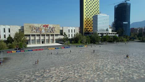 Center-of-Tirana-capital-in-Albania,-paved-square-with-colorful-marble-tiles,-national-museum-and-hotels