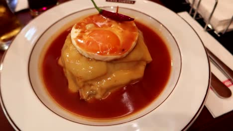 Close-up-view-of-a-Francesinha,-a-traditional-delicacy-from-Porto,-Portugal