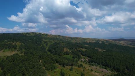 Wolken-Hängen-Am-Morgen-über-Einem-Riesigen-Wald-Auf-Einer-Bergkette-Und-Hügeln-Mit-Kiefern,-Wunderschöne-Panoramaaufnahme-Des-Naturhintergrunds-In-Voskopoja,-Albanien