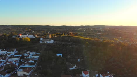 Drone-shot-of-a-tower-on-a-ridge-by-a-small-village-in-Alentejo-in-Portugal