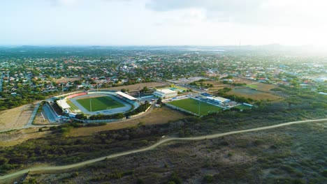 SDK-Stadion-Ergilio-Hato-football-stadium-in-curacao,-panoramic-aerial-establishing-at-midday