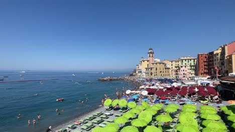 Tourists-sunbathe-and-play-water-activities-in-Camogli,-Italy