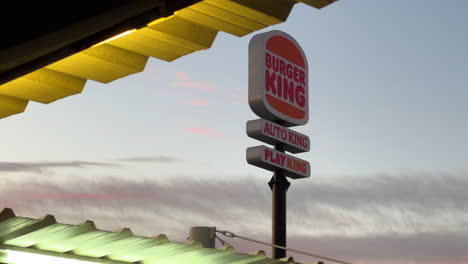 Burger-King,-Auto-King-and-Play-King-sign-with-nice-sunset-in-Estepona-Spain,-4K-shot