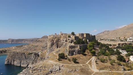 Ancient-greek-temple,-acropolis-Lindos-on-Rhodes,-aerial-orbit-on-a-sunny-day
