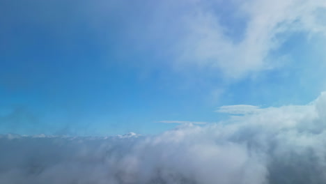 A-drone-flies-through-a-cloudscape-on-a-blue-sky-day
