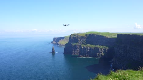 Static-shot-of-a-drone-ready-to-start-flying-over-the-famous-Cliffs-of-Moher,-Ireland