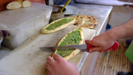 Baked-pitas-are-being-sliced