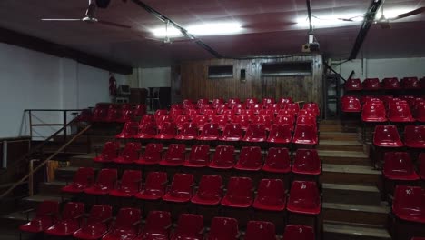 Empty-theater-hall,-red-bleachers-with-no-spectators