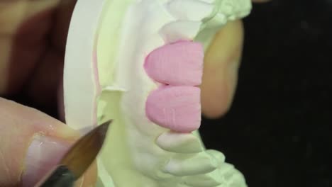 dental-technician-layering-ceramic-crown-on-central-incisors-precisely