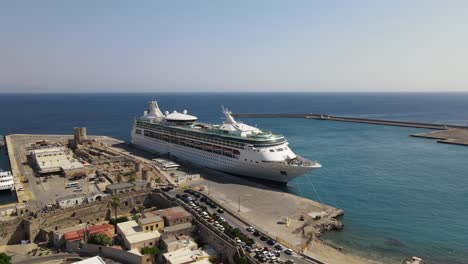 Aerial-orbit-around-large-cruise-ship-in-Kolona-Harbor-Rhodes,-Greece,-sunny