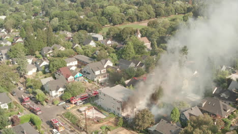 Aerial-shot-towards-Fire-engines-surrounding-a-burning-building