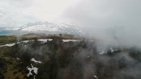 4K-Establishing-Shot-of-Hiking-Trail,-Cliff-with-White-Snow-and-a-lot-of-misty-fog---Cinematic-Drone-Shot